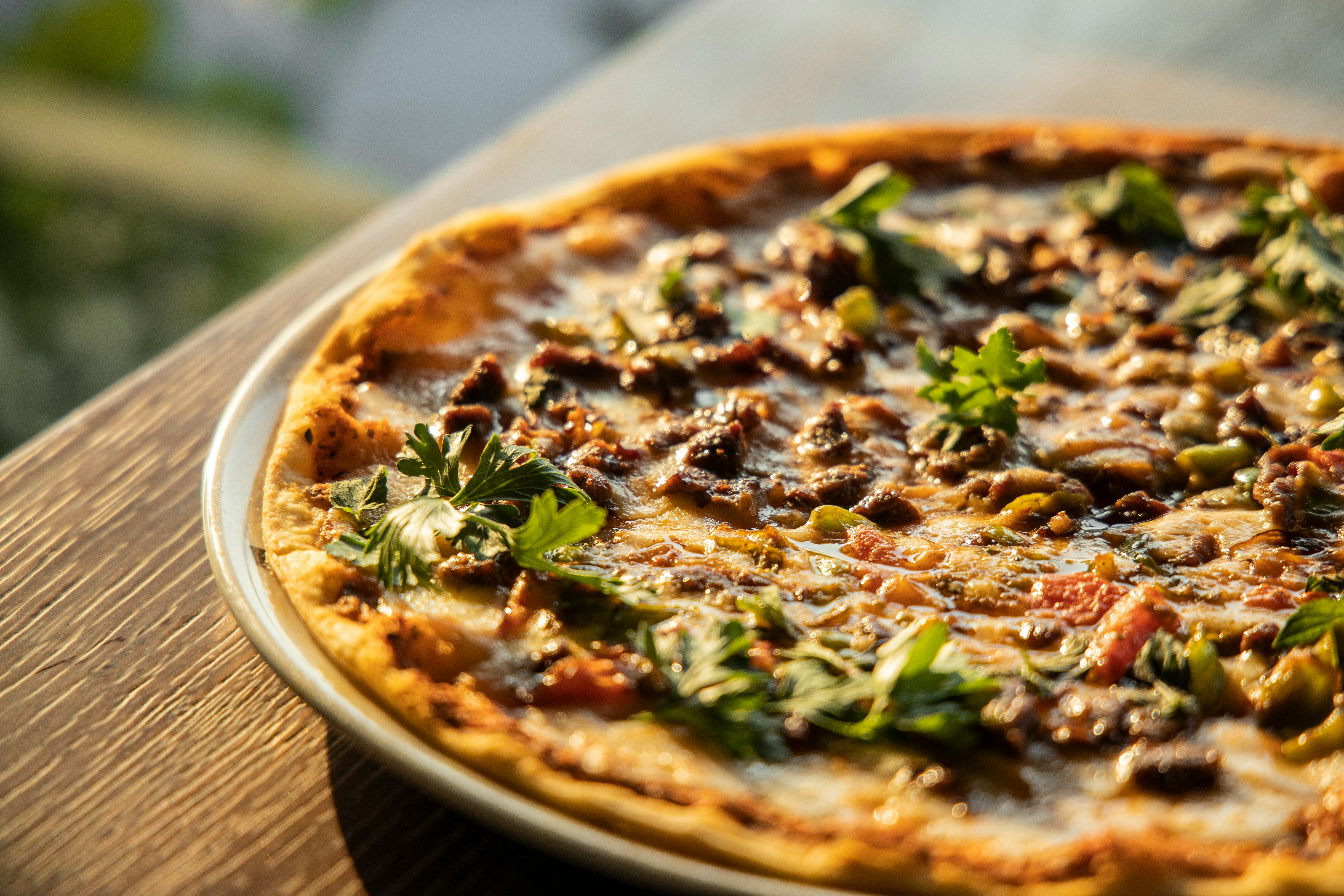Juicy beef and onion pizza on a wooden table